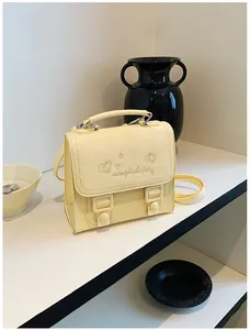 Sweet cream yellow crossbody bag for girls with cute embossed heart and flower designs