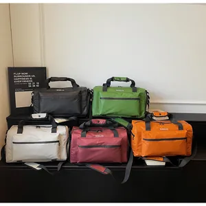 Selection of colorful large capacity travel duffel bags for gym, hiking and business trips.