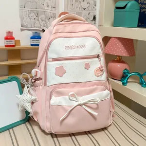 Detailed view of cute pink school backpack with star print and bow accent