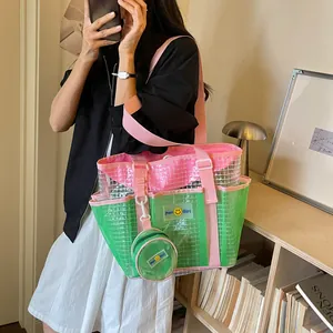 Fashionable large capacity green and pink mesh tote bag with a matching small coin pouch