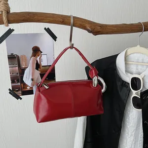 Minimalist retro red pillow handbag with glossy patent leather finish and stylish knot handle detail