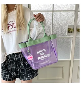Lifestyle shot of a stylish purple mesh tote bag with green handles for summer