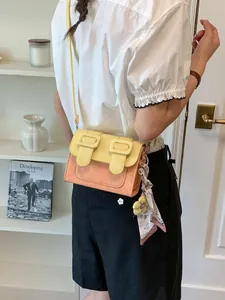 Stylish color-block crossbody square bag shown worn with a casual lifestyle outfit
