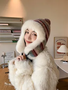 Detailed close-up showing the knit texture and faux fur lining of the winter hat