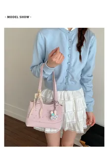 Elegant pink polka dot handbag featuring lace bow and rabbit charm shown on model