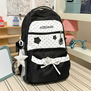 Detailed view of cute black and white polka dot student backpack with star print and bow