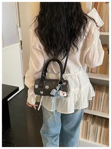 Black cylinder handbag with cute cartoon cat patterns and decorative blue bow