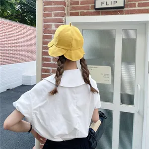Back view of a women's yellow fisherman hat with stylish petal-shaped lotus edges.