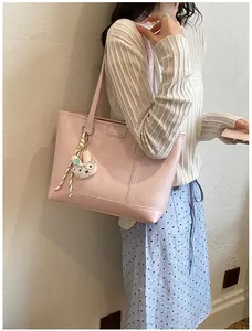 Pink tote bag detail view showing large capacity shoulder bag with cute rabbit charm design.