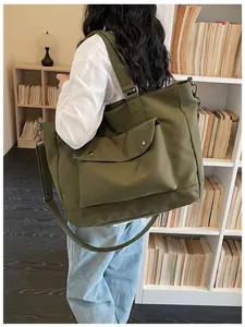 Large olive green canvas tote bag for women shown in a cozy library lifestyle setting.