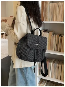 Detail view of a lightweight black and white checkered casual backpack for women