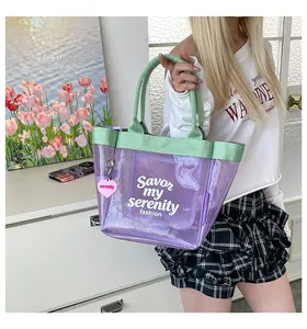 Transparent purple mesh tote bag with mint green handles held by a model