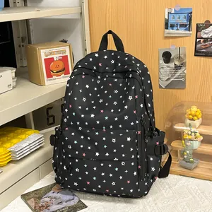 Close-up detail of a stylish black backpack with a vibrant colorful star pattern print