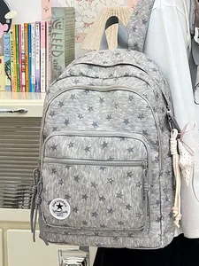 Large capacity grey backpack with star patterns and stylish charms for school girls.