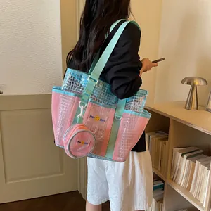 Detail view showing the large pink and blue mesh tote bag with small matching pouch
