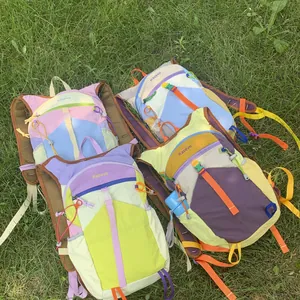 Colorful Dopamine style outdoor hiking backpacks for women displayed on natural green grass.