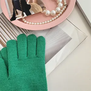 Detailed texture of vibrant green knitted winter gloves for women's cold protection