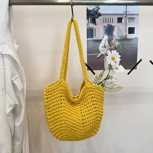 Detailed view of vibrant yellow handmade crochet shoulder bag with intricate knit texture