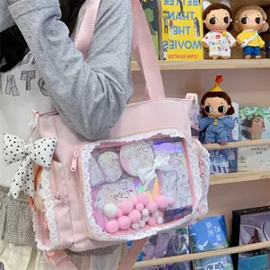 Detailed view of a pink ita bag with a lace-trimmed transparent display window.