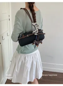 Fashionable color-contrast Boston underarm shoulder bag worn by model in lifestyle setting