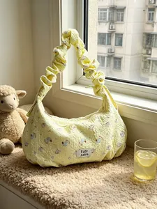 Stylish yellow floral quilted dumpling shoulder bag with elegant ruffled strap design