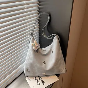 Detailed shot of light blue multi-functional backpack with silver butterfly accents and bunny