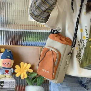 Detailansicht einer beigen Canvas-Beuteltasche mit orangefarbenen Gittertaschen