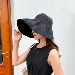 Side view of a wide-brim black sun hat with butterfly pattern detail