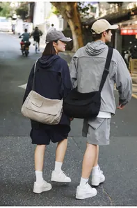 Casual canvas messenger bags shown on models for a lifestyle street view look.