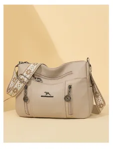 Large capacity beige crossbody bag featuring multi-layer zippers and elegant patterned strap