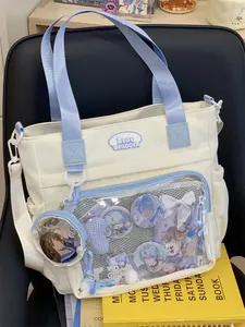 Detailed view of white and blue canvas ita-bag featuring a clear window for anime merch