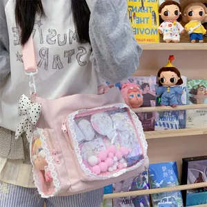 Close-up of pink ita bag featuring clear lace-trimmed display window for anime items