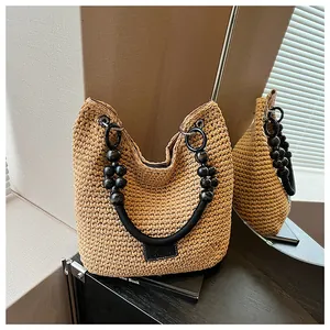 Detailed view of a fashionable hand-woven bucket bag with unique beaded handles