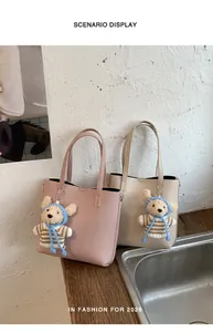 Detail of lychee pattern bucket bags with cute teddy bear pendants in a room setting