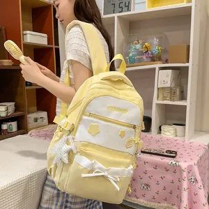 Close-up of a large capacity yellow school backpack with cute star prints and bow detail