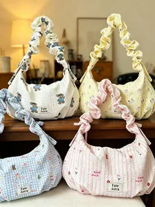 Group of colorful ruffled hobo bags in cute bear, floral, and striped patterns