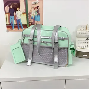 Detail view of mint green Japanese style ita-bag with silver straps and clear window