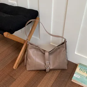Stylish khaki hobo tote bag made of soft faux leather displayed in a cozy interior setting