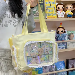 Yellow canvas ita bag with lace trim and large clear display window for anime pins