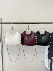 Stylish crescent handbags with metal handles and silver studs in white, red, and black