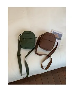 Detailed view of dark green and brown minimalist crossbody phone bags