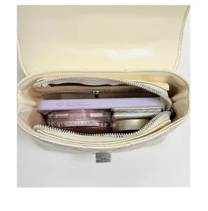 Detailed interior view of the cream quilted crossbody bag showing daily storage capacity