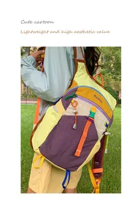 Back view of a colorful dopamine color block hiking backpack being worn outdoors