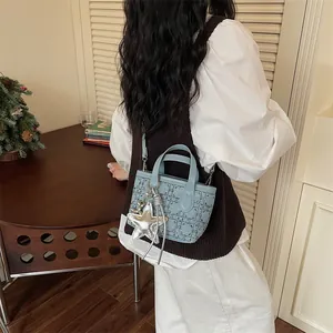 Light blue crossbody bucket bag for women featuring a chic metallic silver star charm