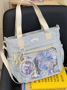 Detail view of a light blue ita bag featuring a transparent pocket for character badges.