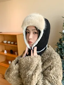 Detailed view of women's warm winter trapper hat with beige faux fur ear protection