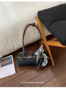 Detailed lifestyle view of black Boston bag with gingham ribbon and dog accessory