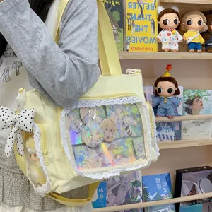 Detailed view of yellow canvas ita-bag with lace trim and clear display window