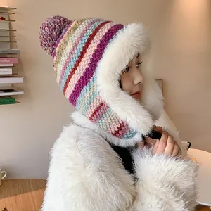 Cozy colorful striped women's knit winter hat featuring plush white faux fur earflaps