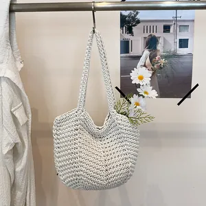 Detailed macro view of a white handcrafted crochet tote bag with beautiful daisy accents